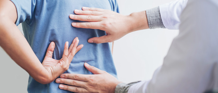 a doctor with his hands on patients back