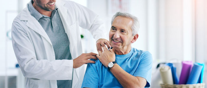 a doctor with his hand on patients shoulder